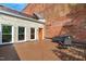 Wide outdoor deck featuring wood-like flooring, a brick wall, an orange door, and patio furniture at 323 W Main St # C, Durham, NC 27701