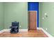 Room features hardwood floors and a blue door with exercise equipment at 323 W Main St # C, Durham, NC 27701