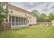 Large backyard features a screened porch, brick firepit, and manicured lawn at 3809 Victorian Grace Ln, Apex, NC 27539