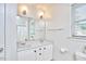 Well-lit bathroom with a double vanity, large mirror, and white fixtures at 3809 Victorian Grace Ln, Apex, NC 27539