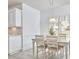 Cozy breakfast nook with white cabinets, a pendant light, and a window view at 3809 Victorian Grace Ln, Apex, NC 27539