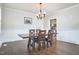Elegant dining room with dark hardwood floors and a wooden table with seating for four at 3809 Victorian Grace Ln, Apex, NC 27539