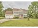 Traditional two-story home with yellow siding, grey shutters, a red door, and a long driveway at 3809 Victorian Grace Ln, Apex, NC 27539