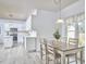 Bright kitchen with white cabinets, stainless steel appliances, and a cozy breakfast nook at 3809 Victorian Grace Ln, Apex, NC 27539