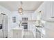 Well-lit kitchen featuring white cabinetry, stainless steel appliances, and center island at 3809 Victorian Grace Ln, Apex, NC 27539