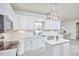 Bright kitchen with white cabinets, countertops, stainless appliances and an island with pendant lighting at 3809 Victorian Grace Ln, Apex, NC 27539