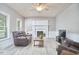 Cozy living room with fireplace, large windows, and neutral paint, creating a relaxing atmosphere at 3809 Victorian Grace Ln, Apex, NC 27539