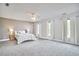 Spacious main bedroom with plush carpet, ample natural light, and neutral paint at 3809 Victorian Grace Ln, Apex, NC 27539