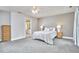 Spacious main bedroom with plush carpet, bedside tables, and ensuite bathroom access at 3809 Victorian Grace Ln, Apex, NC 27539