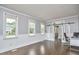 Bright office with hardwood floors, wainscoting, a desk, and sliding barn doors at 3809 Victorian Grace Ln, Apex, NC 27539