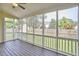 Screened porch with a wood floor, ceiling fan and view of the backyard at 3809 Victorian Grace Ln, Apex, NC 27539