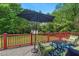 Cozy backyard deck featuring chairs, umbrella, table, and an outdoor rug at 3902 Booker Ave, Durham, NC 27713