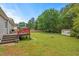 Home's green backyard featuring a fire pit, shed, lush lawn and a seating area at 3902 Booker Ave, Durham, NC 27713