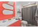 Modern bathroom with coral vanity, designer mirror, and shower at 3902 Booker Ave, Durham, NC 27713