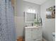 Bathroom featuring a shower with a curtain, and single sink vanity with storage at 3902 Booker Ave, Durham, NC 27713