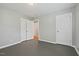 A bright bedroom with neutral paint, hardwood floors, closet space and a door to an additional room at 3902 Booker Ave, Durham, NC 27713