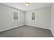 A bright bedroom with neutral paint, hardwood floors, and large windows at 3902 Booker Ave, Durham, NC 27713