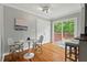 Bright dining area featuring hardwood floors, a table set for two, and sliding glass doors at 3902 Booker Ave, Durham, NC 27713
