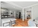 Open kitchen featuring gray cabinets, stainless appliances, hardwood floors, and a breakfast bar at 3902 Booker Ave, Durham, NC 27713