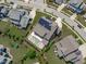 Beautiful aerial view showcasing a backyard pool, patio area, meticulously maintained yard, and solar panels at 400 Chickasaw Plum Dr, Holly Springs, NC 27540