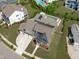 Stunning aerial view of property featuring a long driveway, solar panels, well-maintained lawn, and a private pool at 400 Chickasaw Plum Dr, Holly Springs, NC 27540