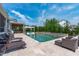This backyard oasis features a pool, pergola, lounge chairs, and plush seating for ultimate relaxation and enjoyment at 400 Chickasaw Plum Dr, Holly Springs, NC 27540