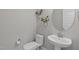 Half-bathroom with a pedestal sink and toilet at 400 Chickasaw Plum Dr, Holly Springs, NC 27540