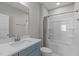 Neutral bathroom with a single sink vanity and tiled shower-tub combination at 400 Chickasaw Plum Dr, Holly Springs, NC 27540