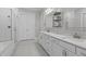 Bright bathroom features double vanity, walk-in shower, and a neutral color palette at 400 Chickasaw Plum Dr, Holly Springs, NC 27540