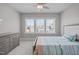 Comfortable bedroom with ceiling fan and large windows overlooking the neighborhood at 400 Chickasaw Plum Dr, Holly Springs, NC 27540