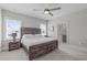 This bedroom offers a spacious setting with a wooden bed frame, carpet floors, and ensuite bathroom at 400 Chickasaw Plum Dr, Holly Springs, NC 27540