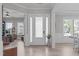Bright foyer featuring wood floors, neutral paint, and views into the living spaces at 400 Chickasaw Plum Dr, Holly Springs, NC 27540