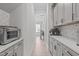 Hallway featuring grey cabinets and light-colored walls at 400 Chickasaw Plum Dr, Holly Springs, NC 27540