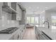 Modern kitchen has stainless appliances, a long island, and an open floor plan at 400 Chickasaw Plum Dr, Holly Springs, NC 27540