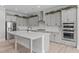 A spacious gray kitchen features a large island, stainless steel appliances, and modern finishes at 400 Chickasaw Plum Dr, Holly Springs, NC 27540