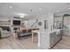 Open-concept living room and kitchen area with a fireplace, dining table, and comfortable seating at 400 Chickasaw Plum Dr, Holly Springs, NC 27540