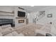 Cozy living room with a modern fireplace, TV, comfortable seating, and neutral color palette at 400 Chickasaw Plum Dr, Holly Springs, NC 27540