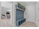 Welcoming mudroom offers seating, storage, and an adjacent entertainment area at 400 Chickasaw Plum Dr, Holly Springs, NC 27540