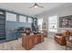 Office with a built-in desk, wood desk, two windows, and an accent wall at 400 Chickasaw Plum Dr, Holly Springs, NC 27540