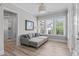 A sunroom with bright windows, a comfortable sofa, and natural light at 400 Chickasaw Plum Dr, Holly Springs, NC 27540