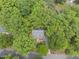 An aerial view of a house surrounded by lush, mature trees in a vibrant, green neighborhood at 404 Trappers Run Dr, Cary, NC 27513
