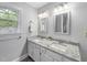 Bathroom with double sink vanity featuring granite counters and modern fixtures at 404 Trappers Run Dr, Cary, NC 27513