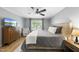 Comfortable bedroom features a large bed, dresser and cozy chair by the window at 404 Trappers Run Dr, Cary, NC 27513