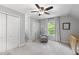 This light bedroom features a ceiling fan, two closets, and a cozy seating area at 404 Trappers Run Dr, Cary, NC 27513