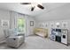 Bright Bedroom room featuring a crib, rocking chair, play kitchen, and soft, neutral decor at 404 Trappers Run Dr, Cary, NC 27513