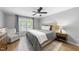 Serene bedroom with a neutral color palette, a comfortable bed, a ceiling fan, and natural light at 404 Trappers Run Dr, Cary, NC 27513