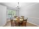Dining room showcasing a wooden table with four chairs and a chandelier at 404 Trappers Run Dr, Cary, NC 27513