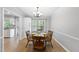 Bright dining room with a wooden table and chairs, and a view into the kitchen at 404 Trappers Run Dr, Cary, NC 27513