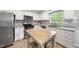 Bright kitchen featuring granite countertops, stainless steel appliances, and a functional kitchen island at 404 Trappers Run Dr, Cary, NC 27513
