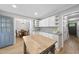 Bright kitchen featuring an island, white cabinets, and stainless steel appliances at 404 Trappers Run Dr, Cary, NC 27513